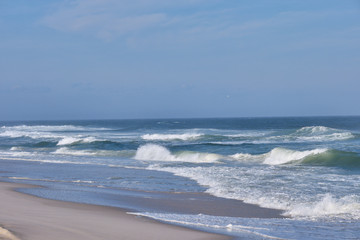 Heavy surf and whitecaps pound the fine sand beach at New Jersey's Island Beach State Park on a...