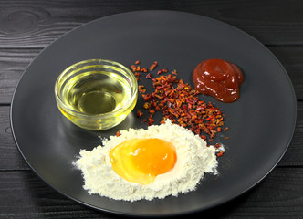 Flour, egg, paprika, baking set. Ingredients for baking pizza. Tomato dough sauce.
