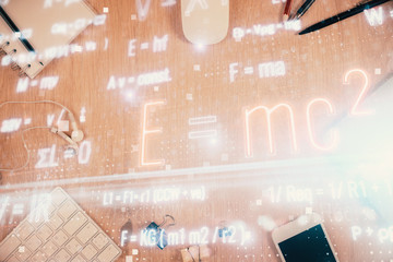 Double exposure of formula drawing over table with phone. Top view. Education concept.