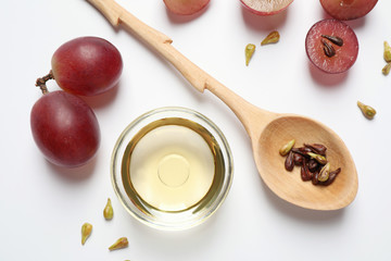 Composition with natural grape seed oil on white background, top view. Organic cosmetic