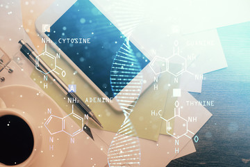 Double exposure of DNA drawing over table with phone. Top view. Science education concept.
