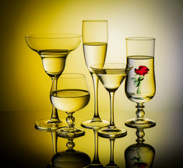 Five glass goblets on a colored background