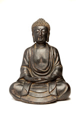 A small replica statue of The Buddha isolated on white