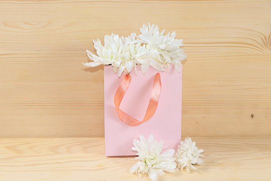 Flowers in a pink box, abstract spring floral background. Creative modern bouquet, minimal holiday concept. Greeting card for Women's Day or Mother's Day, Happy Birthday,