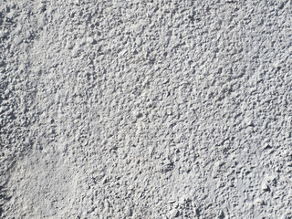 The texture of the grey painted concrete surface.