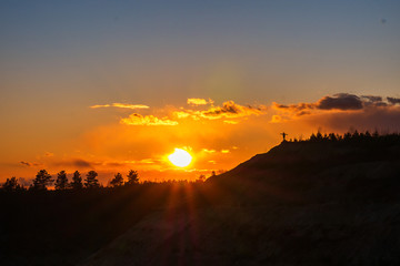 Man spread his hands to the sides towards the sun.