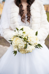 Wedding bouquet in the hands of the bride