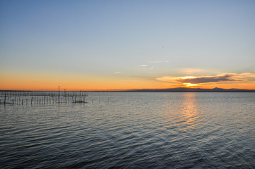 Fototapeta na wymiar Sunset at pier in the Natural Park of the Albufera in Valencia