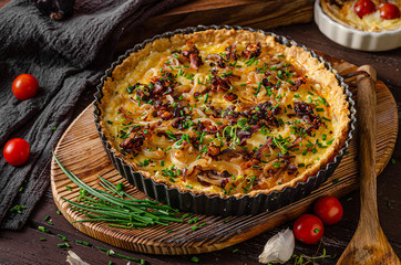 Homemade cheese quiche with onion and bacon