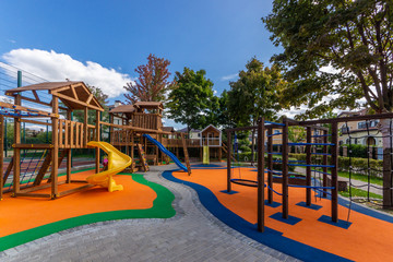 Outdoor play area features toddler children’s play equipment. Colorful playground