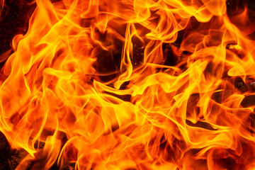 Bright background of burning orange flames, close up