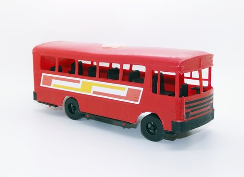 Old red toy bus made of injected plastic. Toy without the manufacturer's brand, a typical toy from the 1970s and 1980s in Brazil. They were sold at fairs. White background.