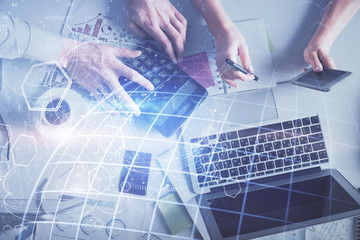 Naklejka premium Double exposure of man and woman working together and world map hologram drawing. international network concept. Computer background. Top View.