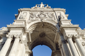Fototapeta na wymiar Arco da Rua Augusta, monumental trimphal arch to the main street of Lisbon, Portugal, seen from Praca do Comercio (Commerce Square), build to commemorate the rebuild of the city after 1755 earthquake