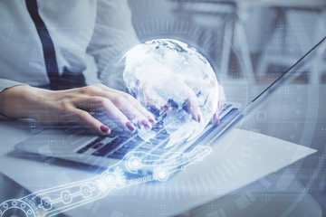 Double exposure of woman hands working on computer and world map hologram drawing. International technology business concept.