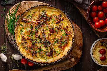 Homemade cheese quiche with onion and bacon