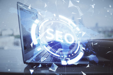 Double exposure of woman hands working on computer and seo hologram drawing. internet search concept.