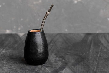 Black gourd with sipped metal straw best use for Yerba Mate tea.