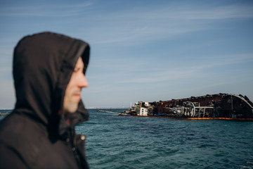 Fototapeta na wymiar ship wreck stranded man hood sea ​​season