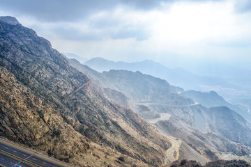 Long exposure of car light trails on a cloudy mountain road at Al Huda, Saudi Arabia