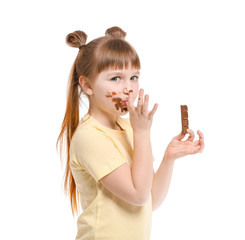 Cute little girl eating chocolate on white background