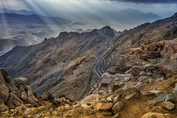 Long exposure of car light trails on a cloudy mountain road at Al Huda, Saudi Arabia