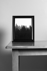 black and white picture frame on a table