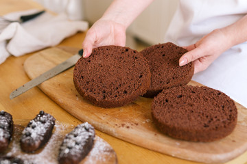 Woman show a chocolate sponge cake, process baking cake