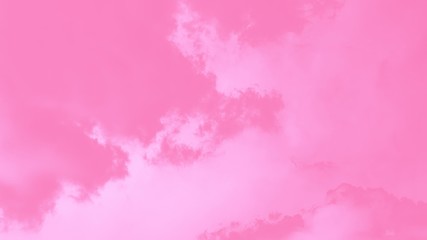 Pastel sky background. Pink sky with fluffy clouds 16:9 panoramic format