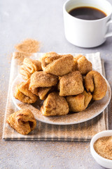 Sugar cookies on a plate, coffee mug, grey background, vertical format.