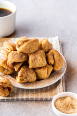 Sugar cookies on a plate, coffee mug, grey background, vertical format.