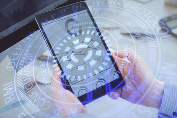 Multi exposure of man's hands holding and using a digital device and data theme drawing. Innovation...