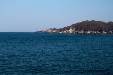 Fototapeta na wymiar Huatulco bay with blue ocean