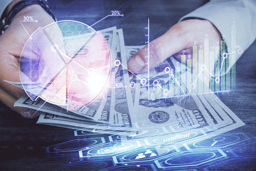 Multi exposure of financial graph drawing hologram and USA dollars bills and man hands. Analysis concept.