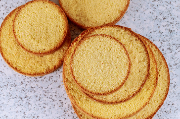 Sliced soft or sponge cake on table for making wedding cake.