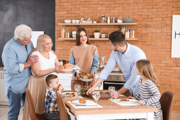 Big family having dinner together in kitchen