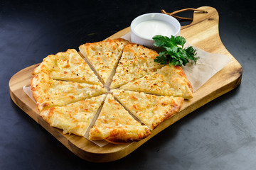 flat bread with cheese on a wooden board