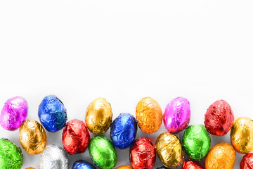 Sweet chocolate eggs on white background