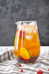Jug of tasty cold tea on table