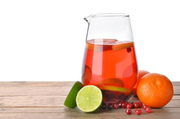 Jug of tasty cold tea on table against white background