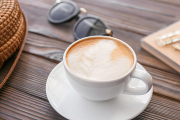 Cup of tasty cappuccino on wooden table