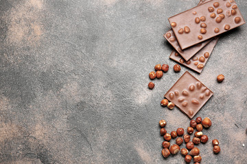 Sweet chocolate with nuts on grunge table
