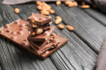 Sweet chocolate with nuts on wooden table