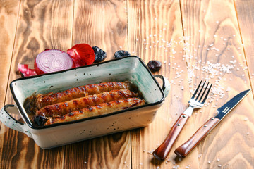 Grilled Munich sausages on wooden background closeup