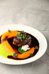 filet mignon restaurant serving with microgreens closeup