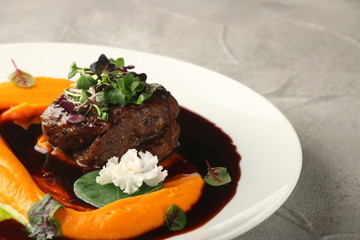 filet mignon restaurant serving with microgreens closeup