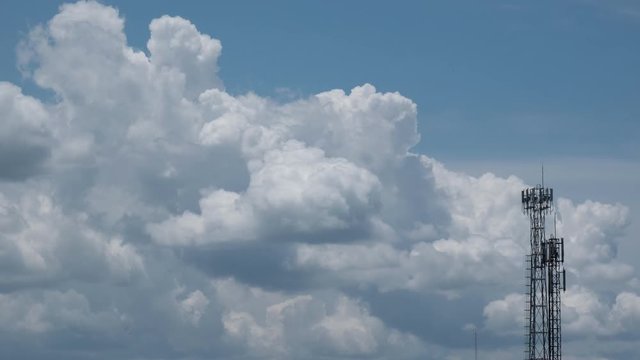 Dramatic cumulonimbus storm clouds bubbling up in the blue sky. Time lapse
