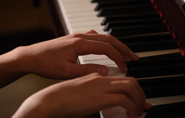 close up teen's hand playing piano