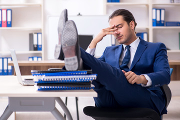 Young male businessman working in the office