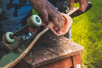 man cleaning an old skate © CarlosAlberto